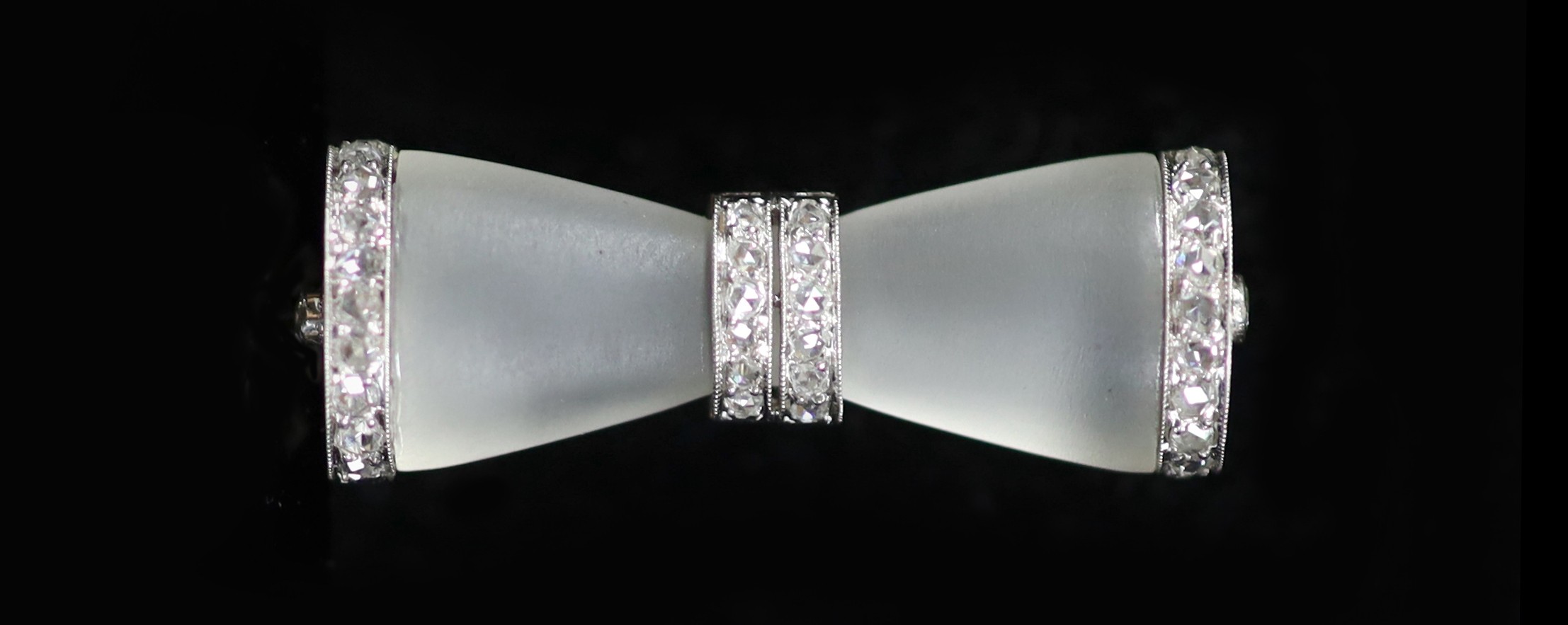 A 1930's/1940's engraved white gold, frosted glass and rose cut diamond set 'bow tie' brooch